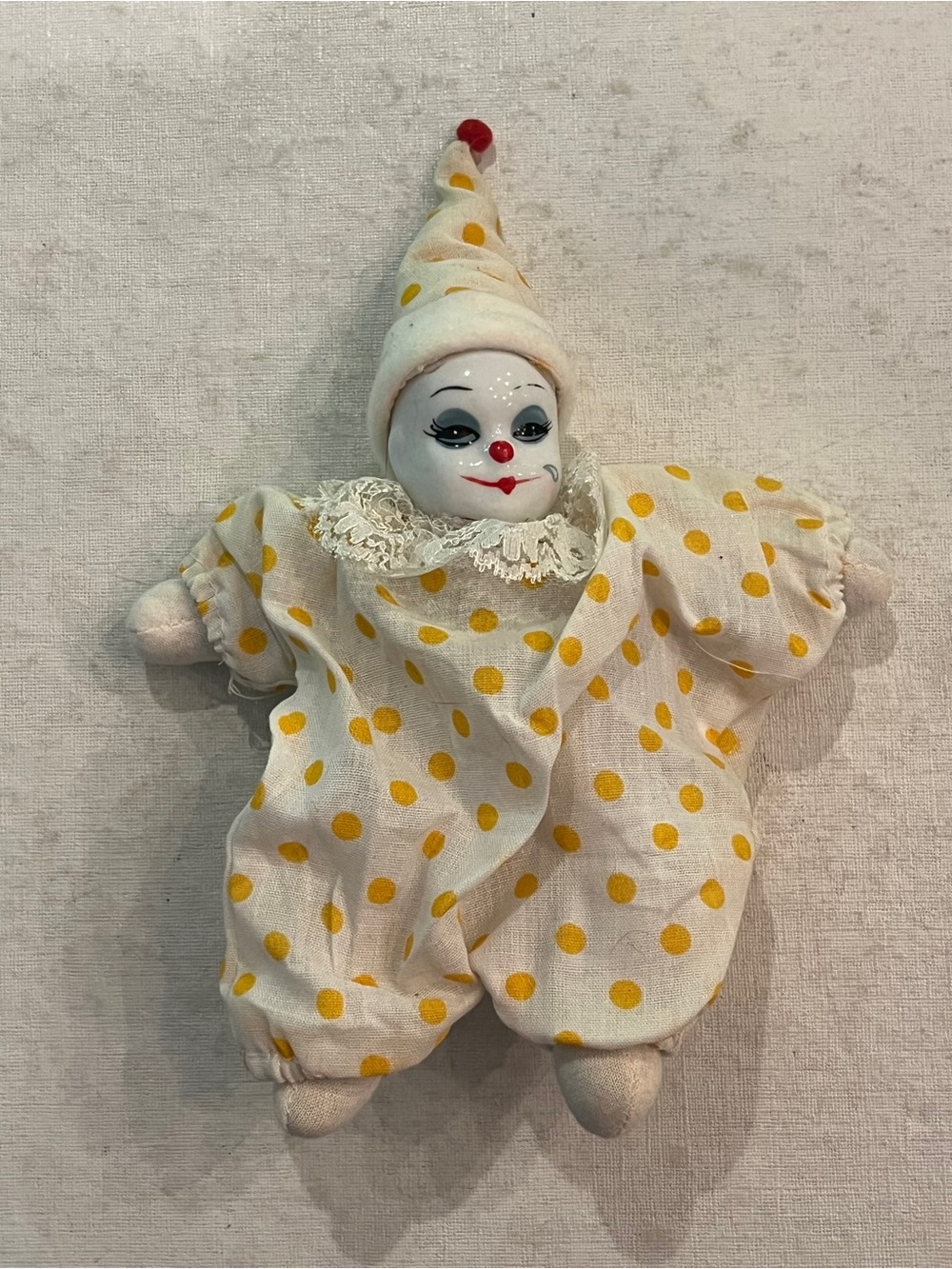 Vintage hand painted Porcelain clown in yellow polka dot jester suit. So cute!